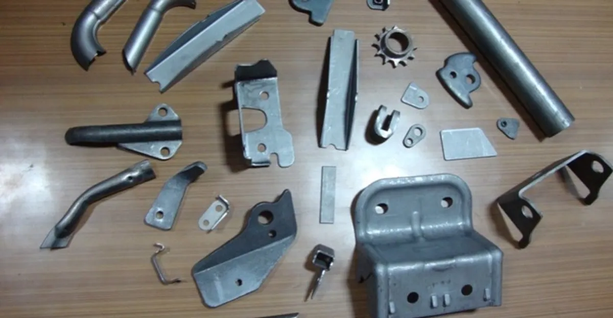 Assorted stamped and formed sheet-metal components including brackets, clips, reinforcements and tubular parts